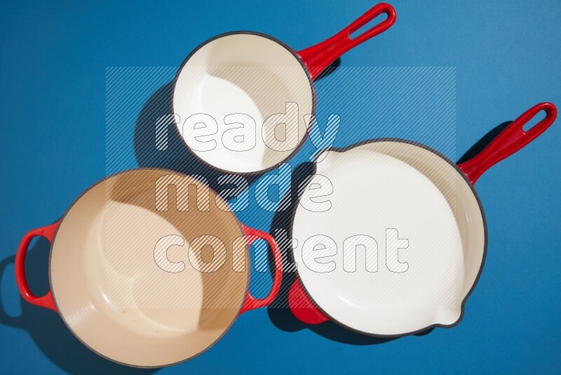 red and white pan and pot on blue background