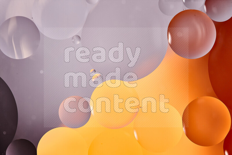 Close-ups of abstract oil bubbles on water surface in shades of white and orange