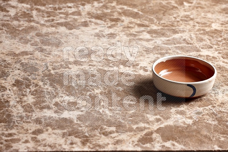 Multicolored Pottery Bowl on Beige Marble Flooring