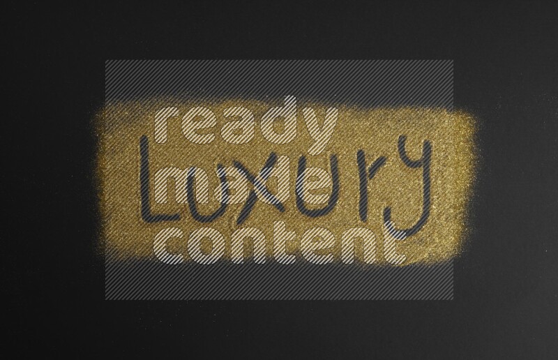 A word written with gold glitter on black background