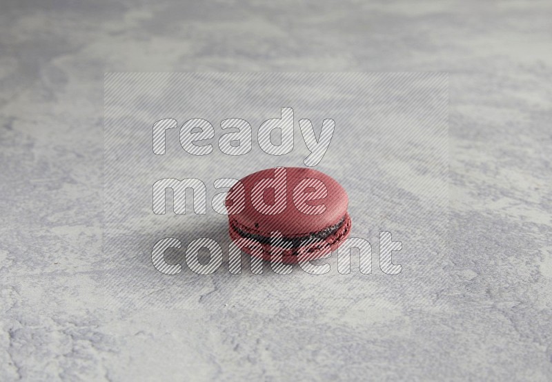 45º Shot of Red Cherry macaron on white  marble background