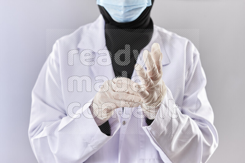 Female doctor wearing an abaya and medical attire in different positions