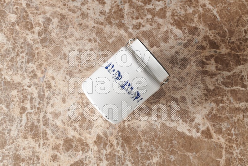 A vintage milk can on beige marble background