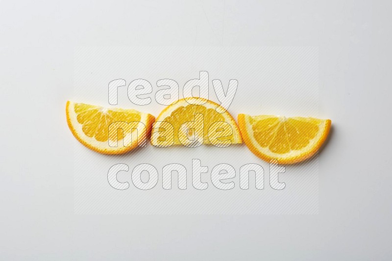 Three halves of an orange slices on white background