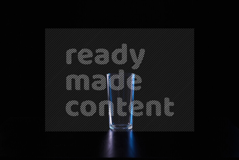 Glassware with rim light in blue and white against black background