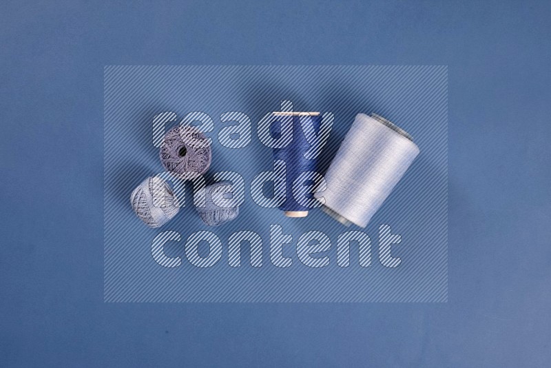 Blue sewing supplies on blue background