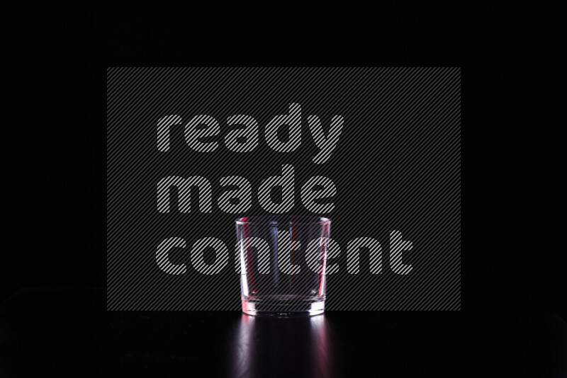 Glassware with rim light in red and white against black background