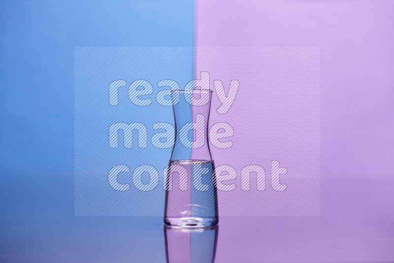 The image features a clear glassware filled with water, set against blue and light purple background