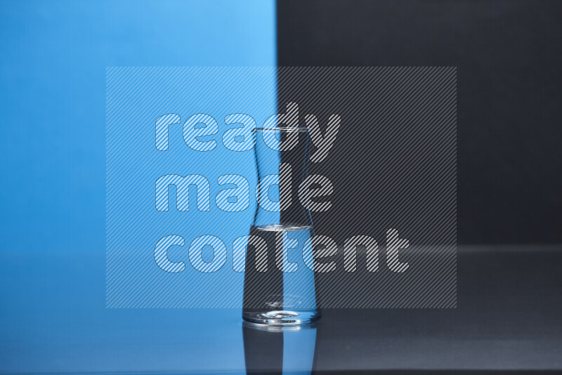 The image features a clear glassware filled with water, set against blue and black background