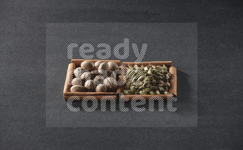 2 squares of cinnamon sticks full of nutmegs and cardamom on black flooring