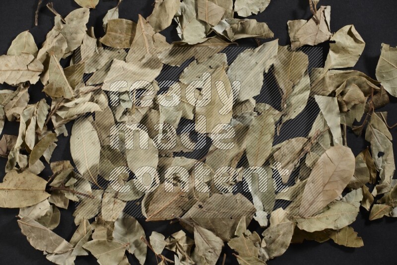 Dried bay leaves on black flooring