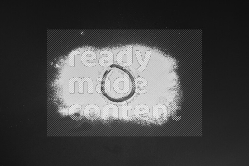 Alphabets written with powder on black background