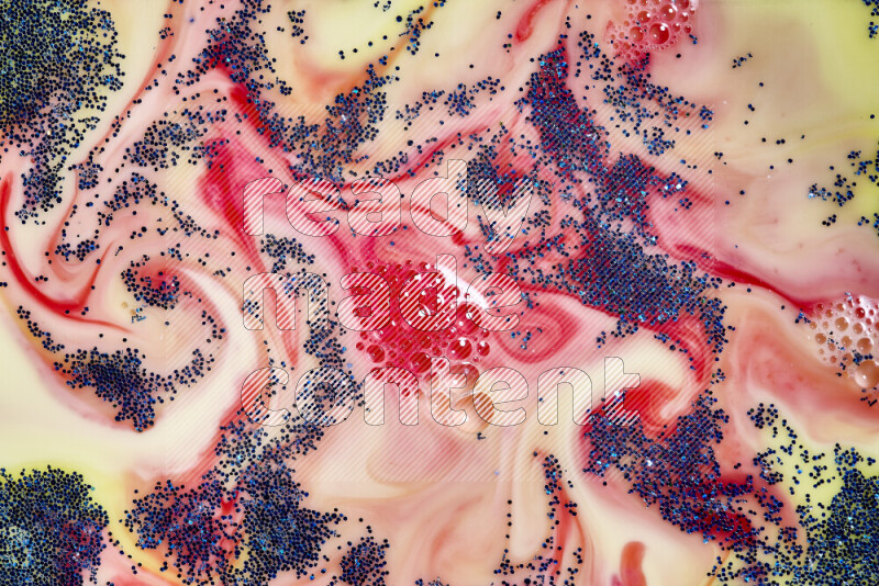 لقطة مقربة لبريق أزرق متلألئ منتشر على خلفية من اللون الأصفر والأحمر في حركات دائرية