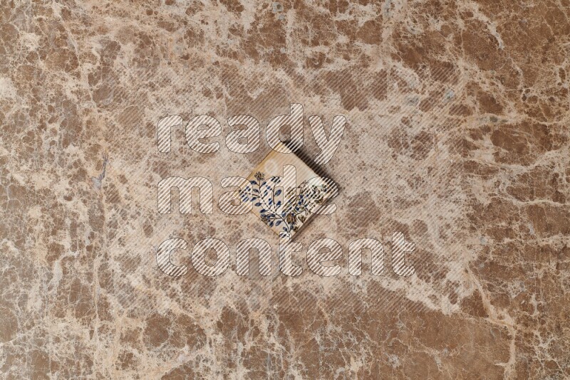 A decorative coaster on beige marble background