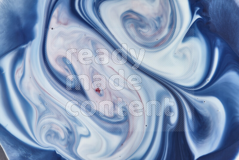 A close-up of abstract swirling patterns in blue, red and white