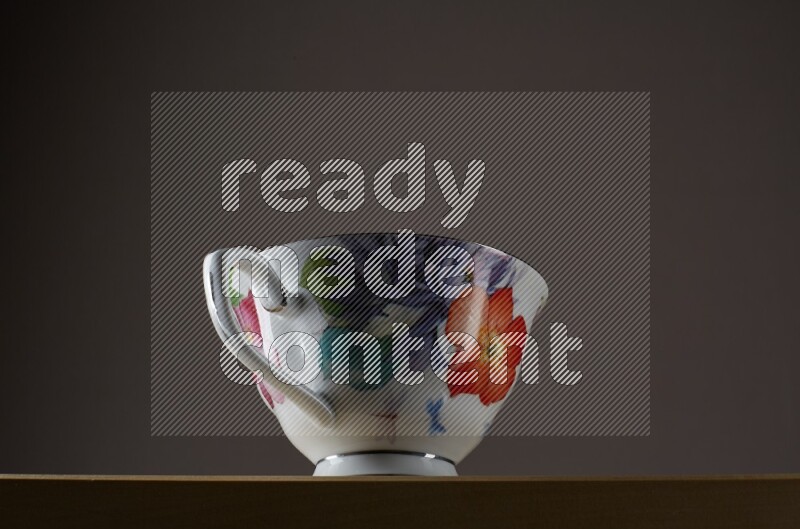 Low angle shot of a decorated cup on grey background