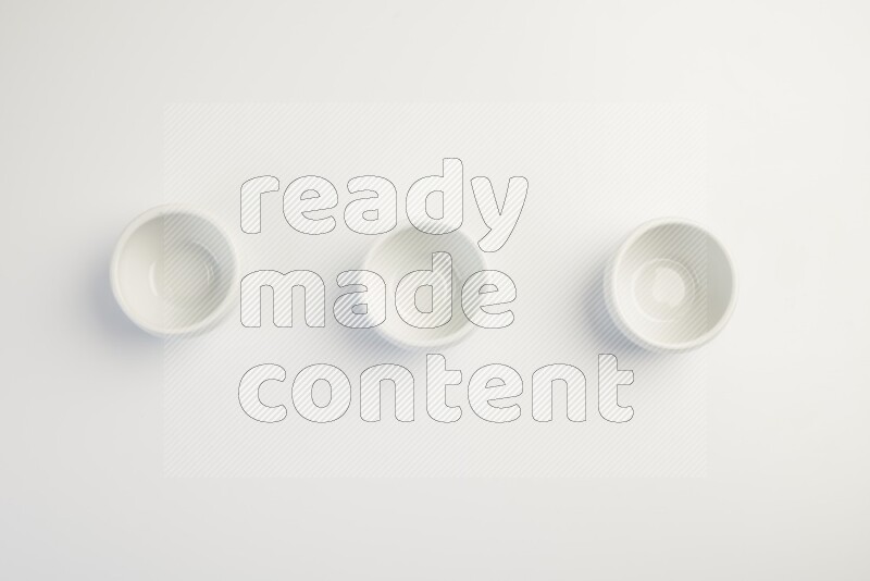 white ceramic round sauce dish on white countertop
