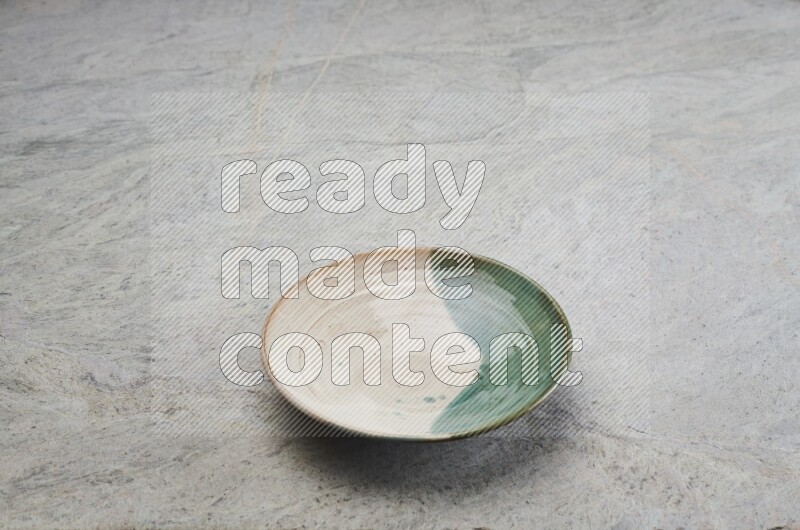 Decorative Pottery Plate On Grey Marble Flooring