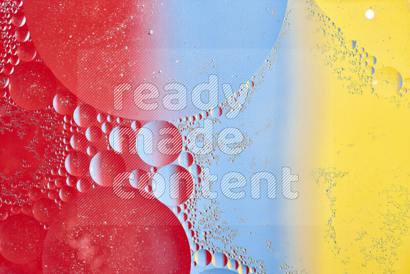 Close-ups of abstract oil bubbles on water surface in shades of yellow, red and blue