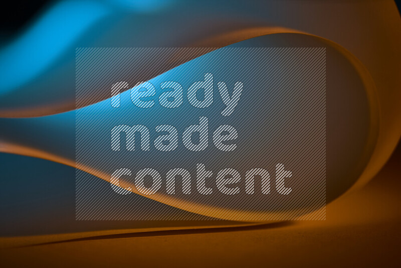 An abstract art piece displaying smooth curves in blue and orange gradients created by colored light