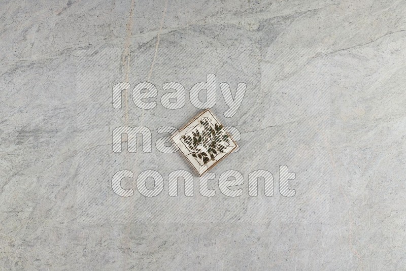 Top View Shot Of A Pottery Coaster tile On Grey Marble Flooring