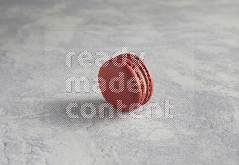 45º Shot of Red Velvet macaron on white  marble background