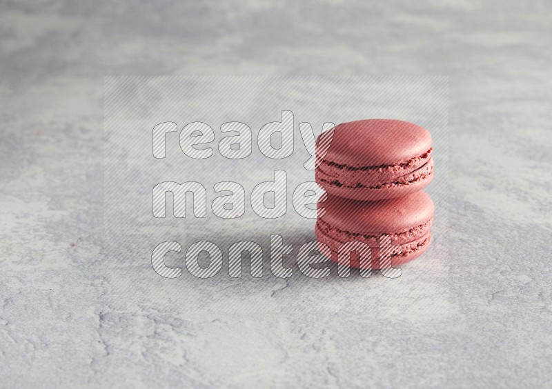 45º Shot of two Pink Raspberry macarons  on white  marble background