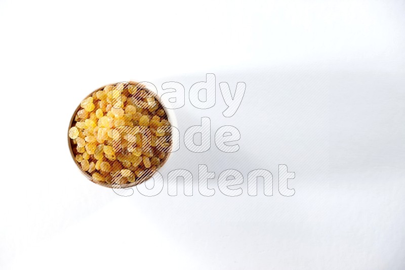 A beige ceramic bowl full of raisins on a white background in different angles