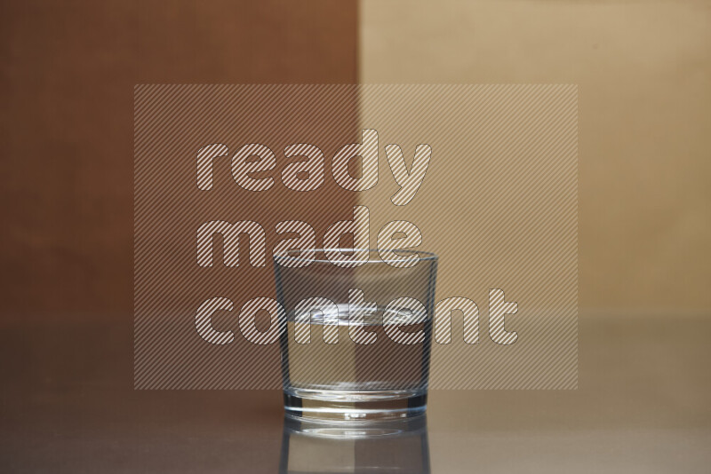 The image features a clear glassware filled with water, set against brown and beige background