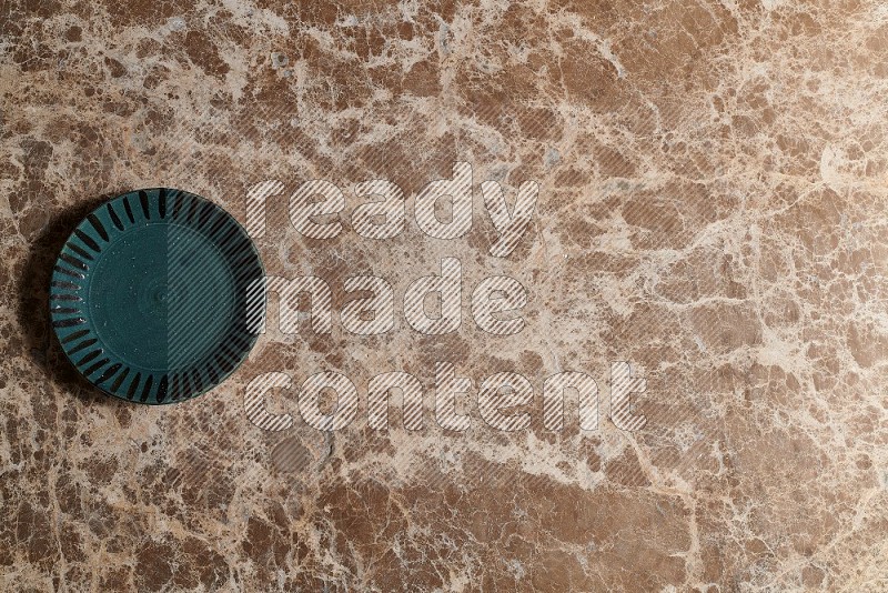 Top View Shot Of A Multicolored Pottery plate On beige Marble Flooring