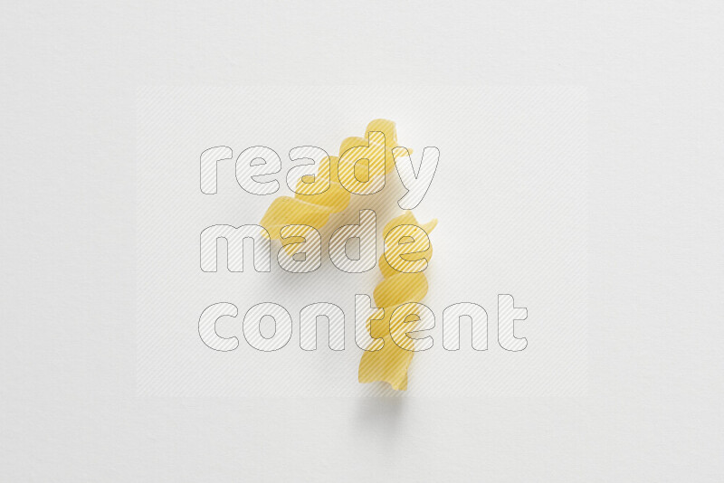 Fusilli pasta on white background