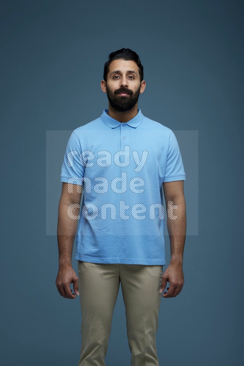 Man posing in a blue background wearing a Blue shirt