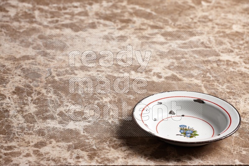 A vintage metal plate on beige marble background