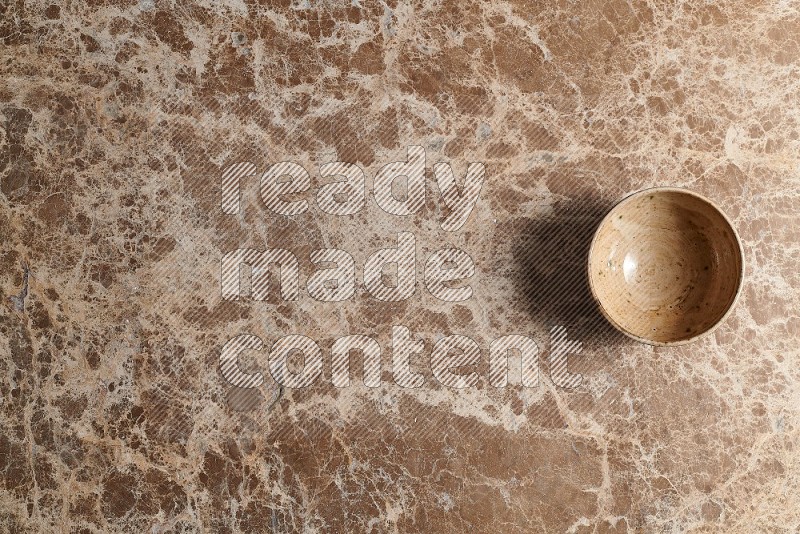 Top View Shot Of A Beige Pottery bowl On beige Marble Flooring