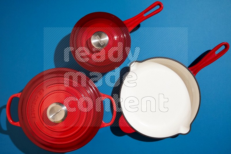 red and white pan and pot on blue background