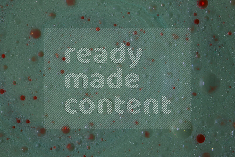 تلتقط الصورة تناثرا للطلاء الأحمر علي خلفية خضراء