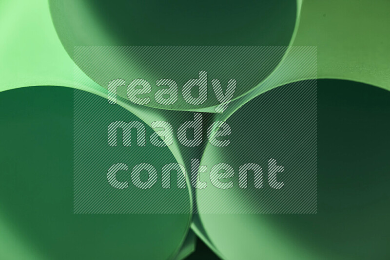 The image shows an abstract paper art with circular shapes in varying shades of green