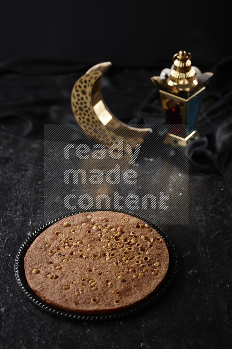 Basbousa with lanterns in a dark setup