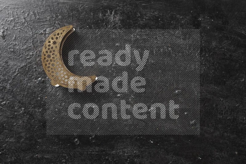 Nuts in a wooden bowl with a wooden lantern in a dark setup