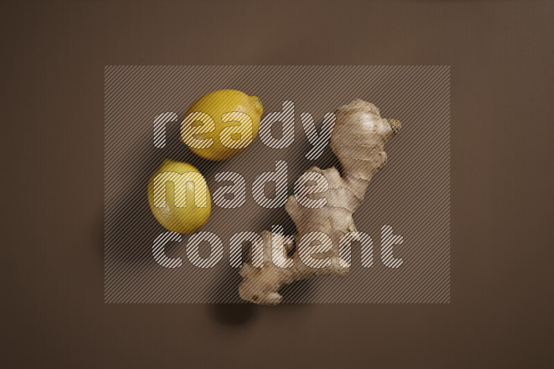 Fresh ginger root with different ingredients such as lemon, orange, honey, ground ginger on beige baackground