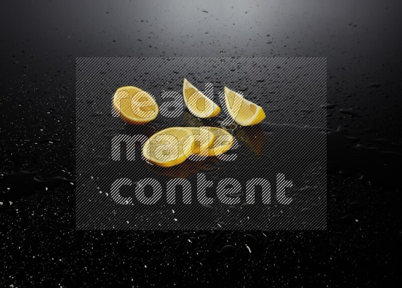 Lemon slices with water drops, and droplets on black background