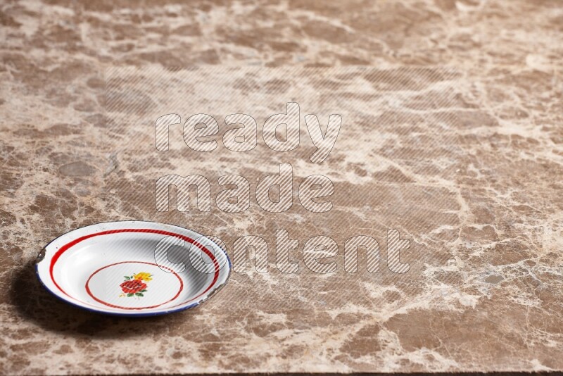 A vintage metal plate on beige marble background