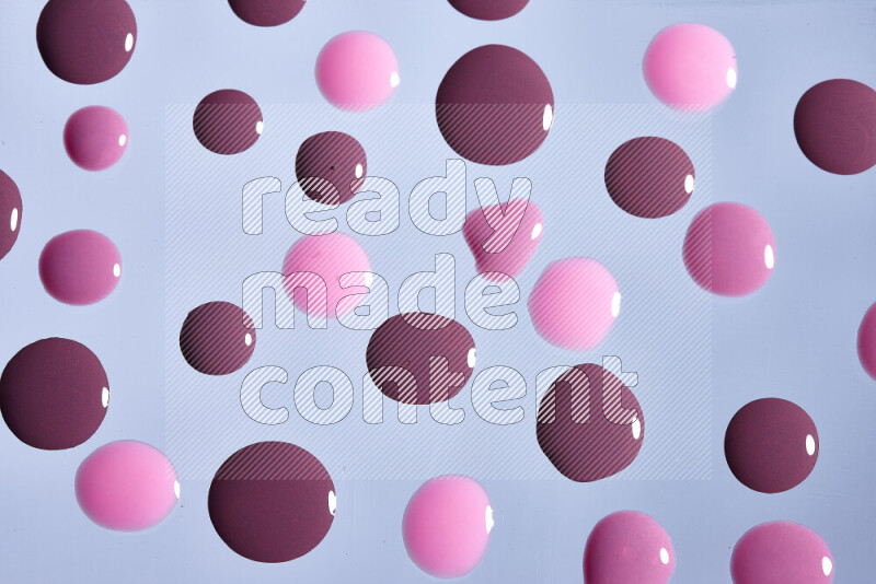 Close-ups of abstract purple and pink paint droplets on the surface