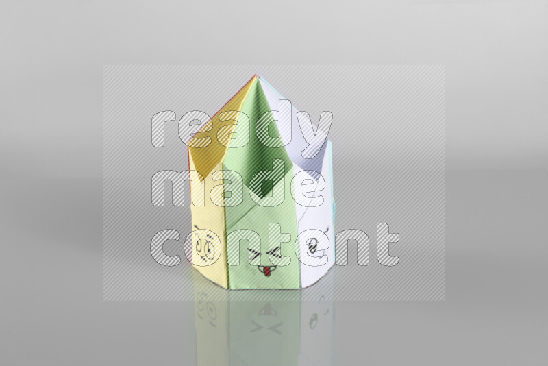 Origami pen holder on grey background