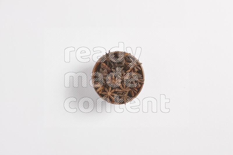 Star Anise in a wooden bowl on white flooring
