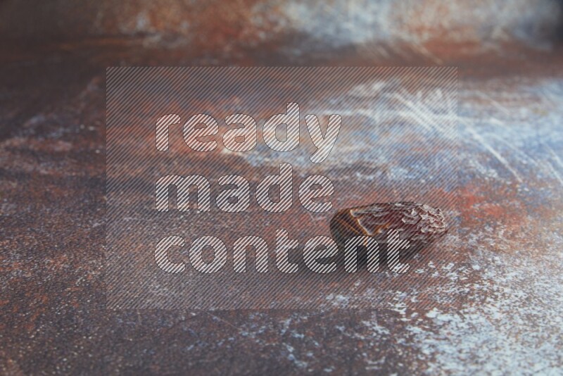 one madjoul date on a rustic reddish background