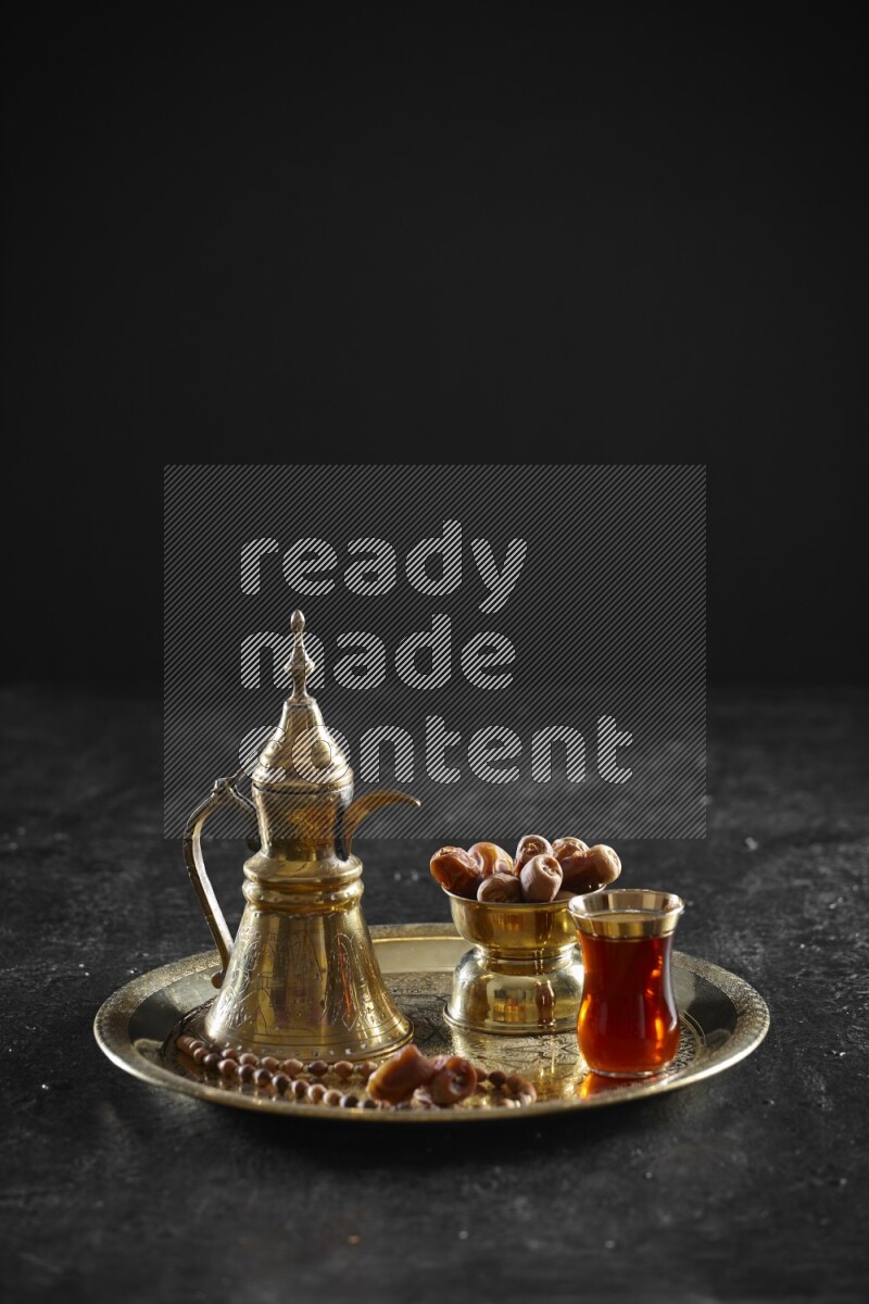 Dates with a drink on a metal tray in a dark setup