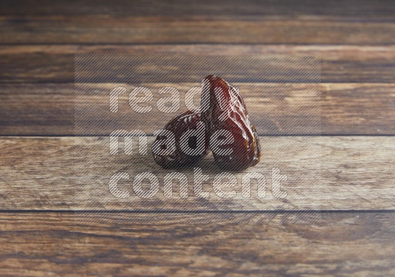 two madjoul dates on a wooden background