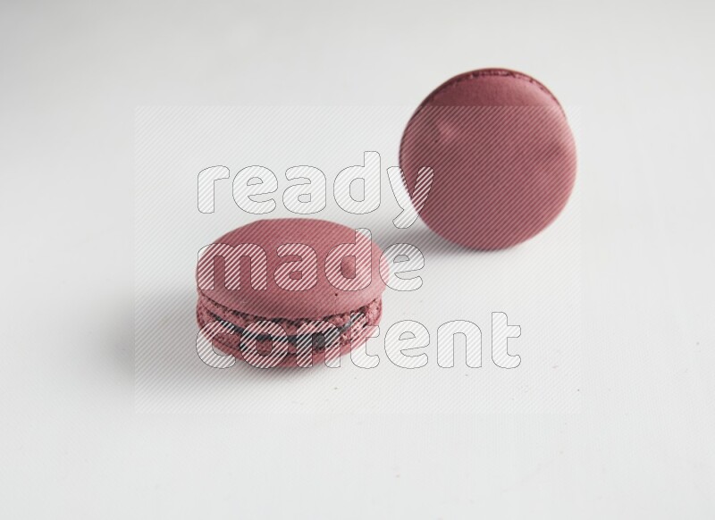 45º Shot of two Red Cherry macarons on white background
