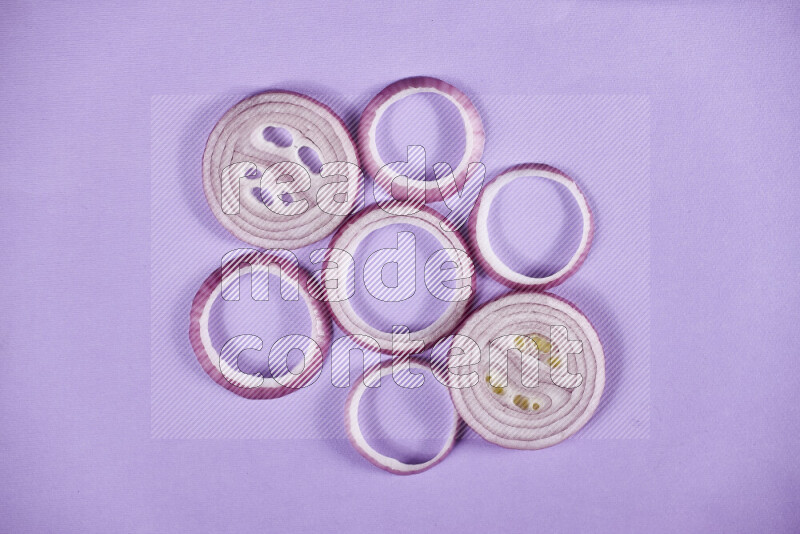 Red onions rings on purple background